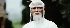 Old man with white beard strokes his beard