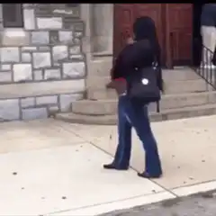 Woman dancing on sidewalk
