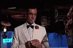 James Bond lights cigar with Rolex watch