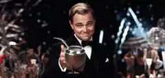 Leonardo DiCaprio toasting with a drink