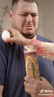Man praying with candle and egg