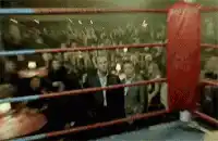 Two men staring intensely in a boxing ring
