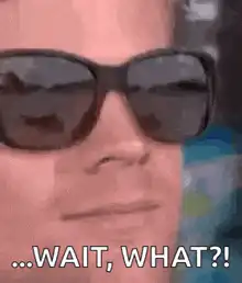 Man takes off sunglasses confused