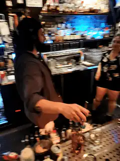Bartender flips a cocktail shaker