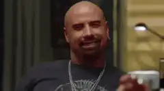 John Travolta smiling and nodding