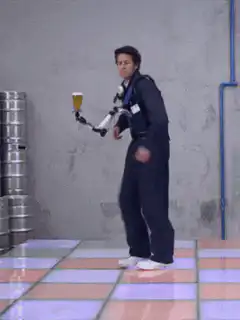Man dancing with robotic beer arm