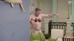 Man in grass skirt and coconut bra dancing