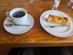 coffee and fruit tart on wooden table