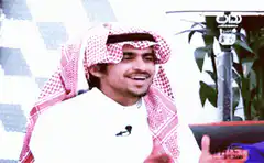 Man in keffiyeh clapping