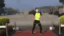 Man in mask dancing on red carpet