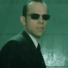 Agent Smith grimacing in rain