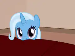 Trixie peeking over couch
