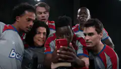 Team takes a selfie and reacts