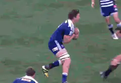 Rugby player tackles opponent