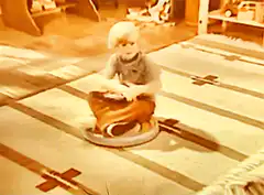 Child spinning on a Sit 'n Spin toy