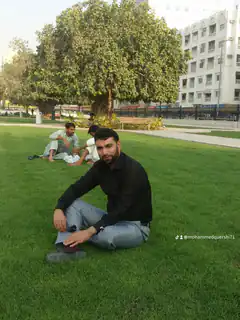 Man sitting on grass in park