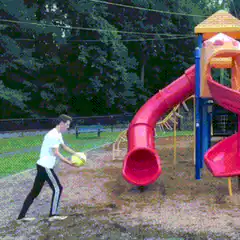 Boy kicks soccer ball into slide