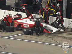 Pit crew member throws tire in frustration