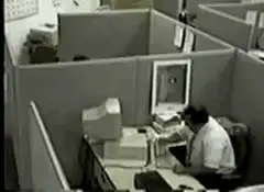 man throws computer monitor in cubicle