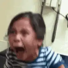 Crying toddler in striped shirt
