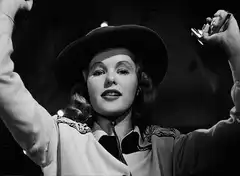 Woman in cowboy hat shoots gun