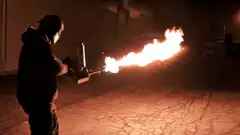 person using a flamethrower at night
