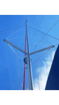 Sailboat mast against blue sky