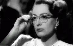 Joan Crawford removes glasses