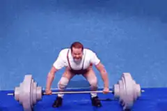 man lifting barbell with legs