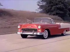 Red and white classic convertible driving