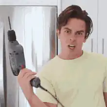 Man holding drill with shocked face