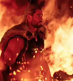 Thor standing in front of fire