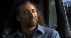 Nicolas Cage smiling in a car