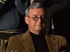 Bob Odenkirk raises glass while men clap