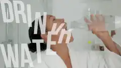 Woman chugs water and spills it