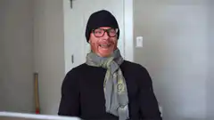 Man in beanie and scarf smiling