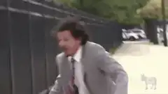 Man in suit screaming at fence