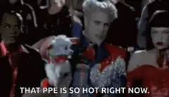 Bill Nye holding a teddy bear with PPE caption