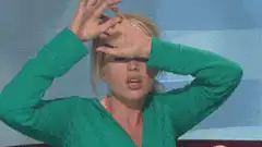 Woman in green shirt facepalms
