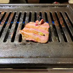 Beef on a grill with a fly