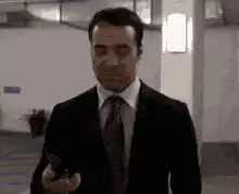 Man in suit throws phone and walks away