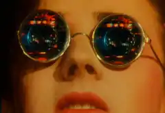 Close-up of woman with round sunglasses