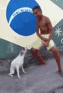 Man dancing with dog in front of flag