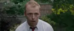 Simon Pegg climbs over a garden wall
