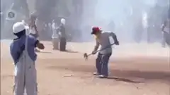 Man swings sledgehammer at ground