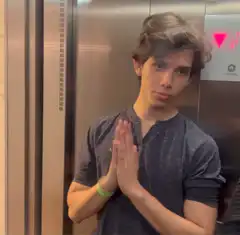 Man in elevator with prayer hands