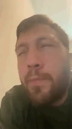 Man blinking and looking up