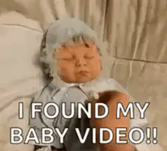 Hand removes baby mask to reveal alien