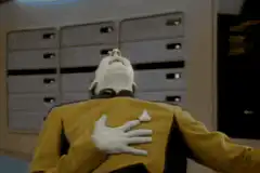 Data removes his mask and laughs