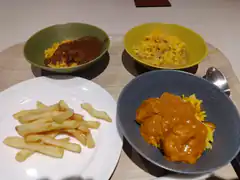 Four bowls of curry and rice with fries